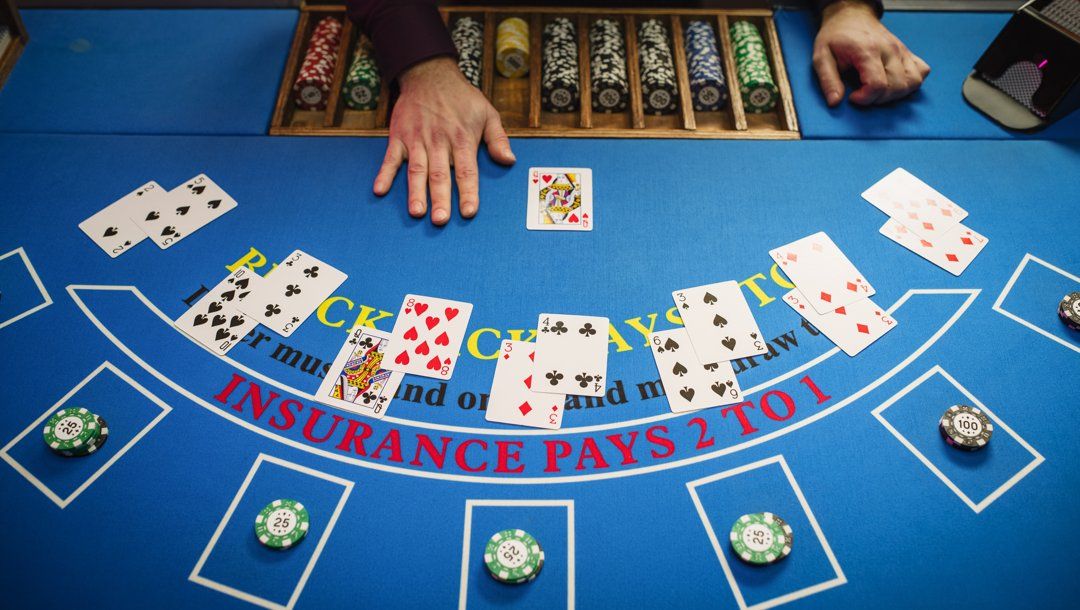 A top-down view of a blackjack table with a game in progress.