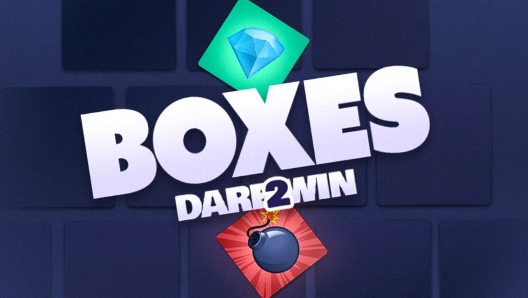 The title screen for Boxes Dare2Win. The game title appears on a blue background with boxes that are a slightly darker blue stacked in a pyramid shape behind it. There is a diamond icon above the title and a bomb icon below it.