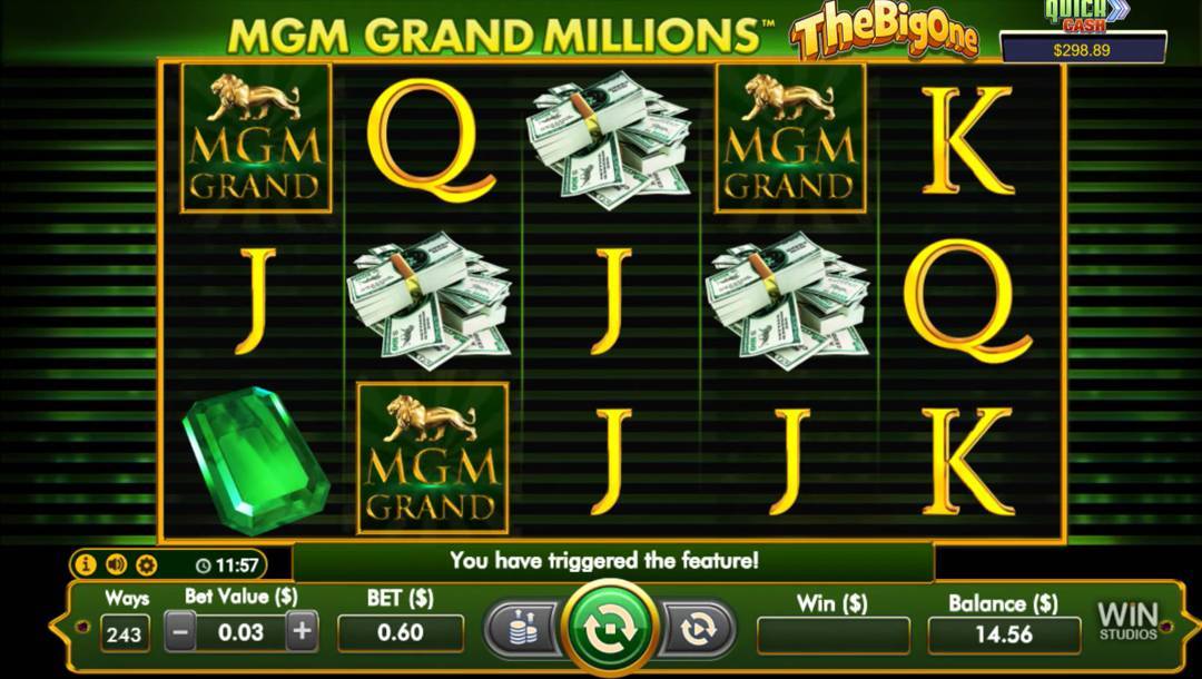 The slot reels in MGM Grand Millions. The background consists of green and black bars with silhouettes visible on the green bars. In the foreground are the slot reels with a golden border. The reels contain various wealth-themed symbols including green gems, stacks of cash, and the MGM Grand symbol. Regular symbols visible on the reels include the K, Q and J.