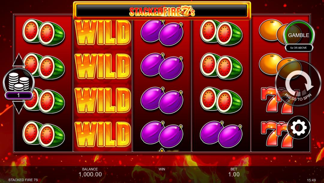 A screenshot of the slot reels in Stacked Fire 7s. The backdrop is red with orange and yellow flames. In the foreground are the slot reels with various classic slot symbols, like orange double 7s, watermelons, plums, and oranges, as well as a fiery wild symbol.