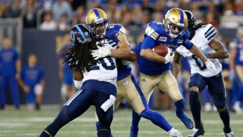 Winnipeg Blue Bombers' Weston Dressler (7) makes the first down against the Toronto Argonauts during the second half of a Canadian Football League game Thursday, July 13, 2017, in Winnipeg, Manitoba.
