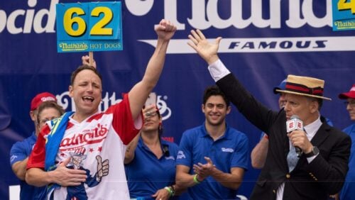 Joey Chestnut celebrates after winning his 16th championship title during the 2023 Nathan's Famous Fourth of July hot dog eating contest in the Coney Island section of the Brooklyn borough of New York, Tuesday, July. 4, 2023.