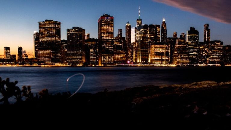 Residential and office buildings light up the New York skyline during sunset, Monday, Sept. 26, 2022, as seen from Brooklyn Bridge Park.