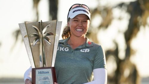 Brooke Henderson holds up the championship trophy after winning the LPGA Hilton Grand Vacations Tournament of Champions.