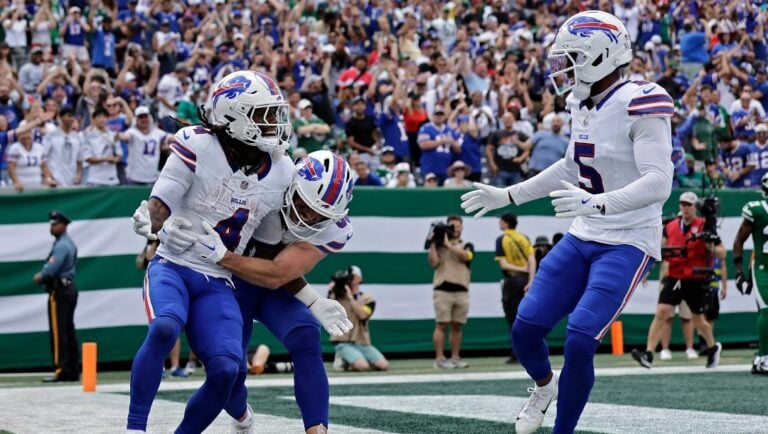 Buffalo Bills running back James Cook (4) celebrates with teammates after scoring a touchdown during an NFL football game against the New York Jets, Sunday, Sept. 14, 2025, in East Rutherford, N.J.
