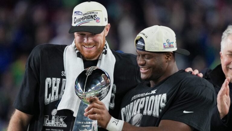 Seattle Seahawks quarterback Sam Darnold and running back Kenneth Walker III, right, celebrate with the Lombardi Trophy after a win over the New England Patriots in the NFL Super Bowl 60 football game Sunday, Feb. 8, 2026, in Santa Clara, Calif.