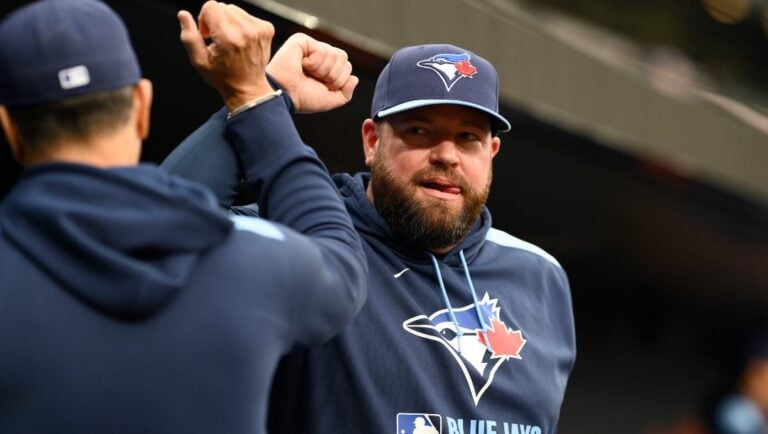 Toronto Blue Jays manager John Schneider, right, looks on before a baseball game against the Baltimore Orioles, Saturday, April 12, 2025, in Baltimore.