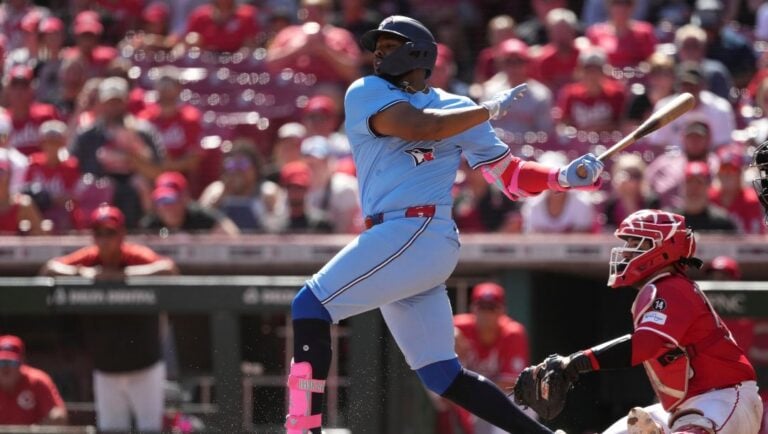 Toronto Blue Jays' Vladimir Guerrero Jr. hits an infield single in the ninth inning of a baseball game against the Cincinnati Reds, Monday, Sept. 1, 2025, in Cincinnati.