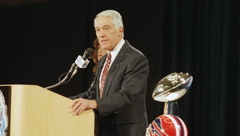 Buffalo Bills coach Marv Levy talks with reporters at a news conference on Friday, Jan. 28, 1994 in Atlanta, with the Super Bowl trophy and a Bills helmet in the foreground.
