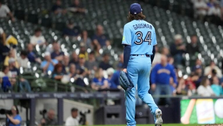 Toronto Blue Jays' Kevin Gausman walks to the dugout during a baseball game against the Milwaukee Brewers, Tuesday, April 14, 2026, in Milwaukee.