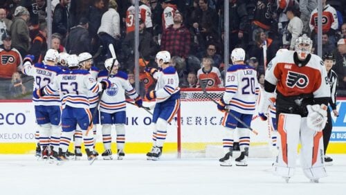 Edmonton Oilers' Jack Roslovic and teammates celebrate his goal against Philadelphia Flyers goaltender Dan Vladar in overtime of an NHL hockey game, Wednesday, Nov. 12, 2025, in Philadelphia.