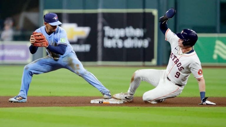 Toronto Blue Jays second baseman Andres Gimenez, left, makes the base tag for the force out on Houston Astros' Zach Dezenzo (9) during a baseball game Wednesday, April 23, 2025, in Houston.