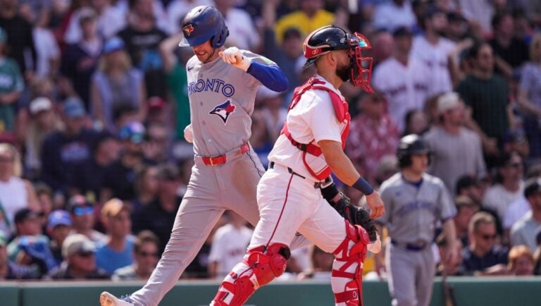 Toronto Blue Jays' Ernie Clement, left, beats the throw to Boston Red Sox catcher Connor Wong while scoring on a double by Brandon Valenzuela, which broke a tie, during the ninth inning of a baseball game against the Boston Red Sox, Thursday, June 18, 2026, in Boston.