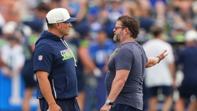 Seattle Seahawks head coach Mike Macdonald, left talks with general manager John Schneider, right, during the NFL football team's training camp, Sunday, July 26, 2026, in Renton, Wash.