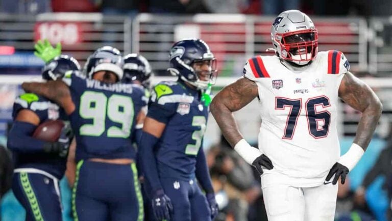 New England Patriots offensive tackle Morgan Moses (76) walks off the field after a touchdown on a fumble recovery by Seattle Seahawks linebacker Uchenna Nwosu during the second half of the NFL Super Bowl 60 football game, Sunday, Feb. 8, 2026, in Santa Clara, Calif.
