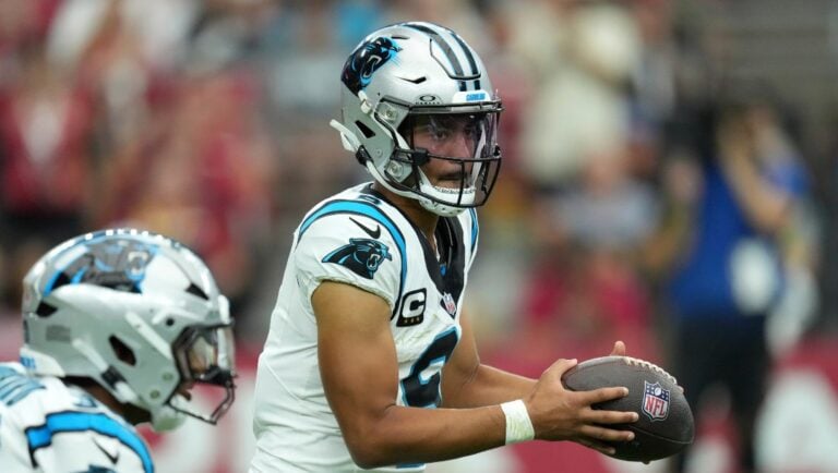 Carolina Panthers quarterback Bryce Young fakes a handoff during the first half of an NFL football game against the Arizona Cardinals Sunday, Sept. 14, 2025, in Glendale, Ariz.