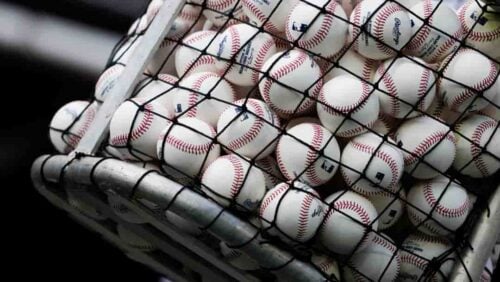 A bucket of baseballs is seen during Seattle Mariners batting practice before an Opening Day baseball game against the Cleveland Guardians Thursday, March 30, 2023, in Seattle.