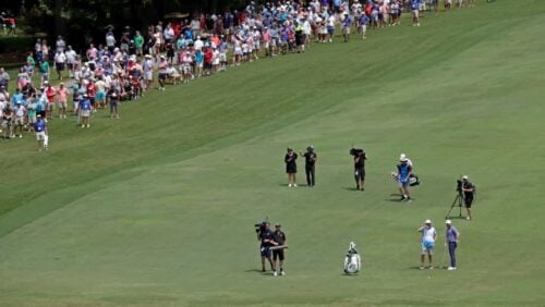 Fans watch as the final group approaches the 18th hole during the final round of the Wyndham Championship golf tournament at Sedgefield Country Club in Greensboro, N.C., Sunday, Aug. 15, 2021